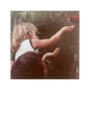 Founder as a child feeding a parrot